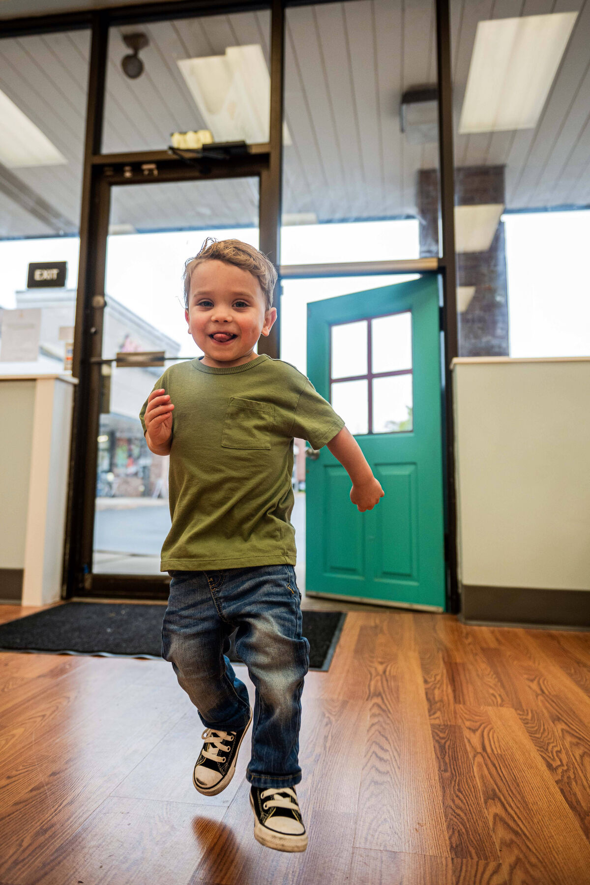 A child running through the front door of Little Lions Play Den