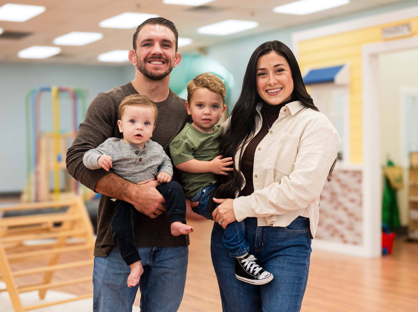 A family with two young children at Little Lions Play Den