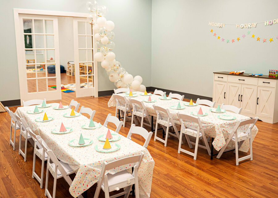 The party room set up with a balloon garland and tables