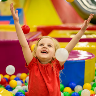 Child playing in ball pit